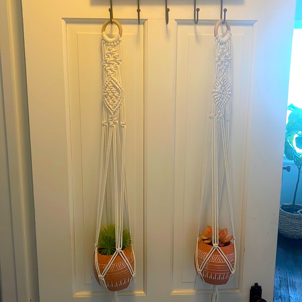 Macramé plant holders with fake plants inside